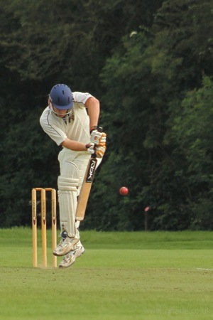 Alex Fends Off A Rising Ball