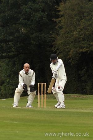 Phil Looks On As Carl Bats