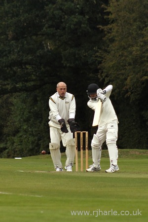 Phil Looks On As Carl Bats